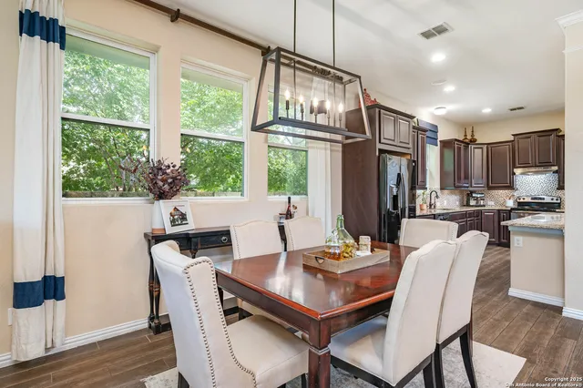 a view of a dining room with furniture window and wooden floor