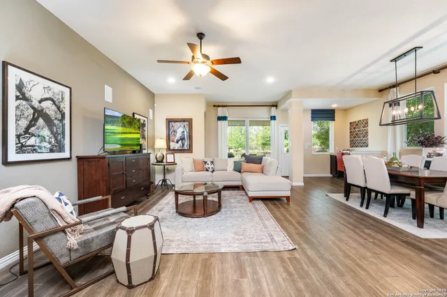 a living room with furniture a dining table and a window