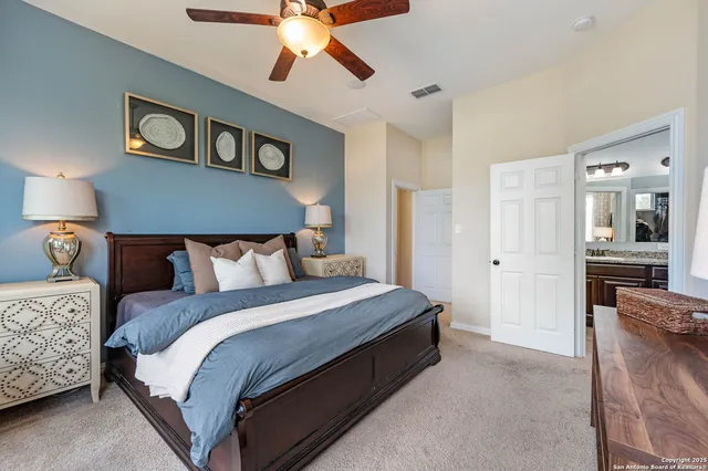 a bedroom with bed and a chandelier