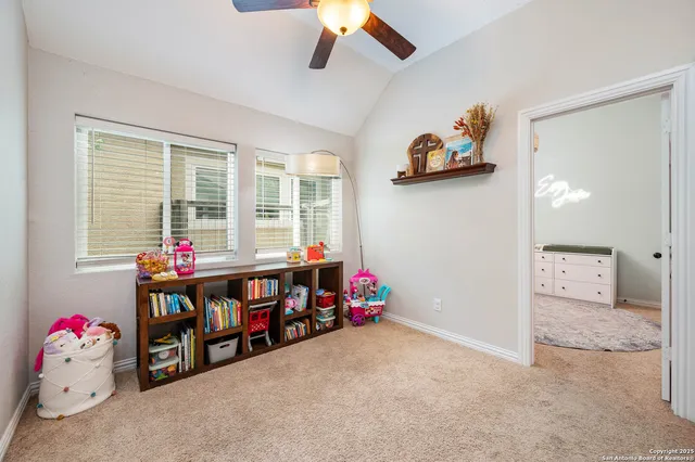 a children room with toys and a chandelier