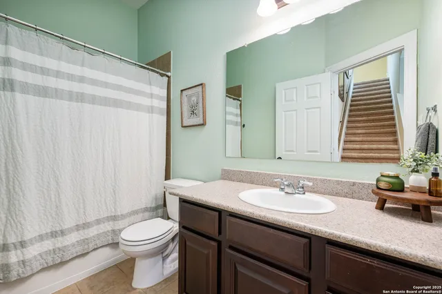 a bathroom with a sink a toilet and a mirror