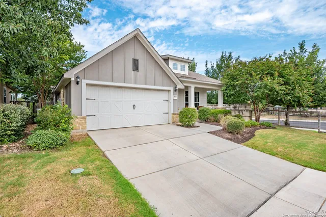 a view of backyard of house with green space