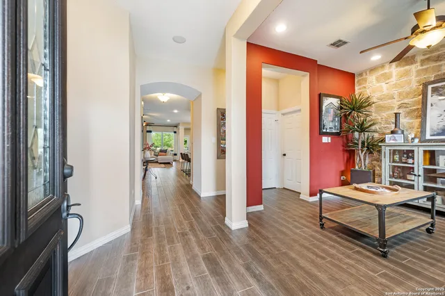 a view of living room filled with furniture and wooden floor