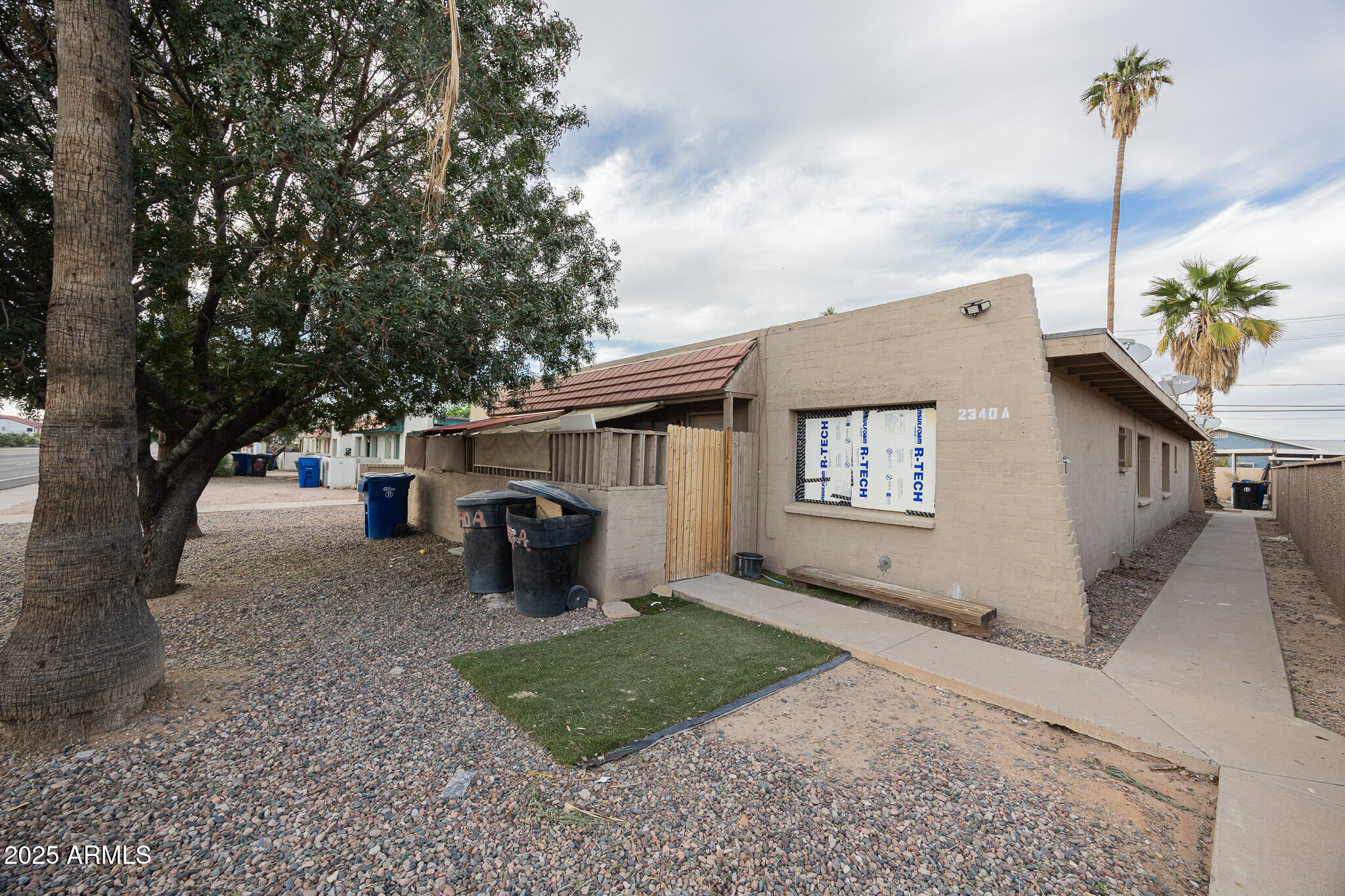 2340 East Broadway Road, Unit A Mesa, AZ 85204 - Photo 1 of 14 a front view of a house with garden