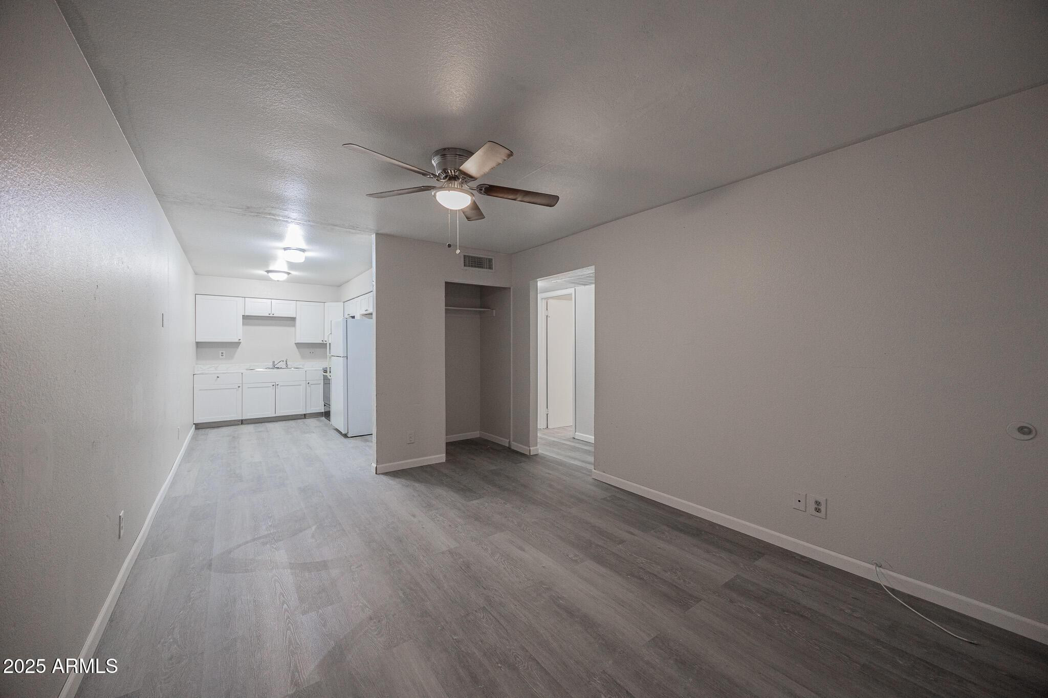 2340 East Broadway Road, Unit A Mesa, AZ 85204 - Photo 3 of 14 a view of a big room with wooden floor and windows