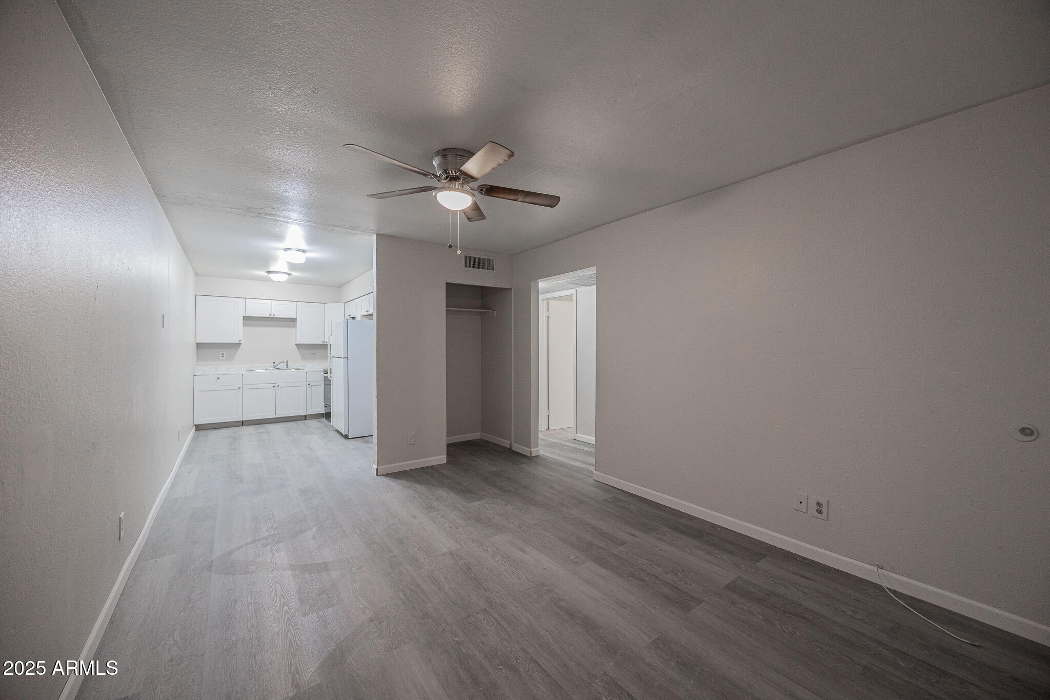 2340 East Broadway Road, Unit A Mesa, AZ 85204 - Photo 3 of 14 a view of a big room with wooden floor and windows