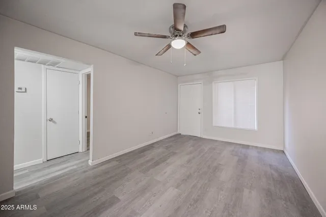 a view of an empty room with wooden floor