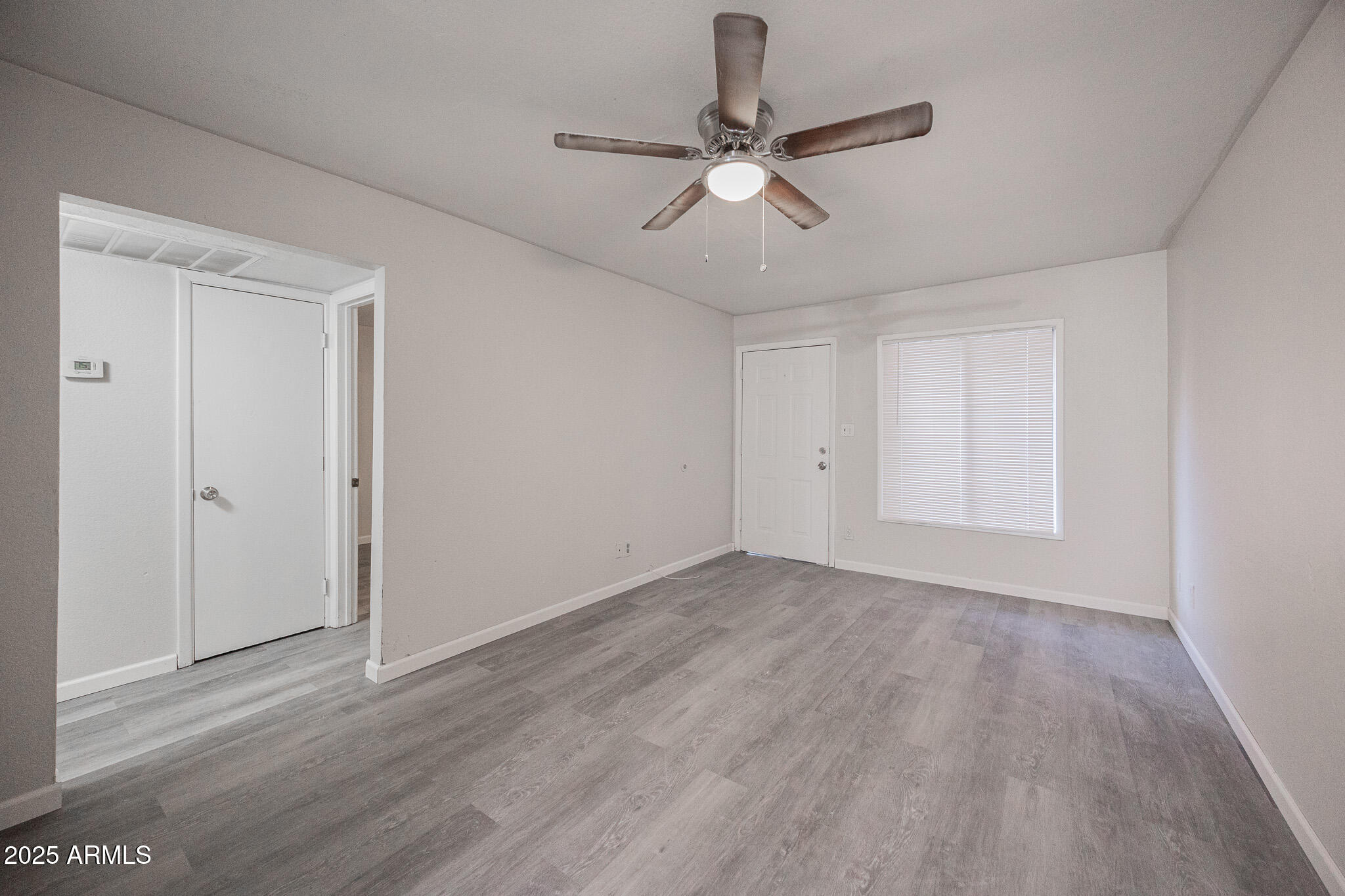 2340 East Broadway Road, Unit A Mesa, AZ 85204 - Photo 4 of 14 a view of an empty room with wooden floor