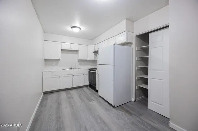 a utility room with cabinets washer and dryer