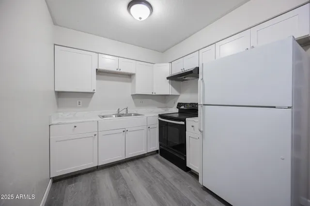 a kitchen with sink cabinets and stainless steel appliances