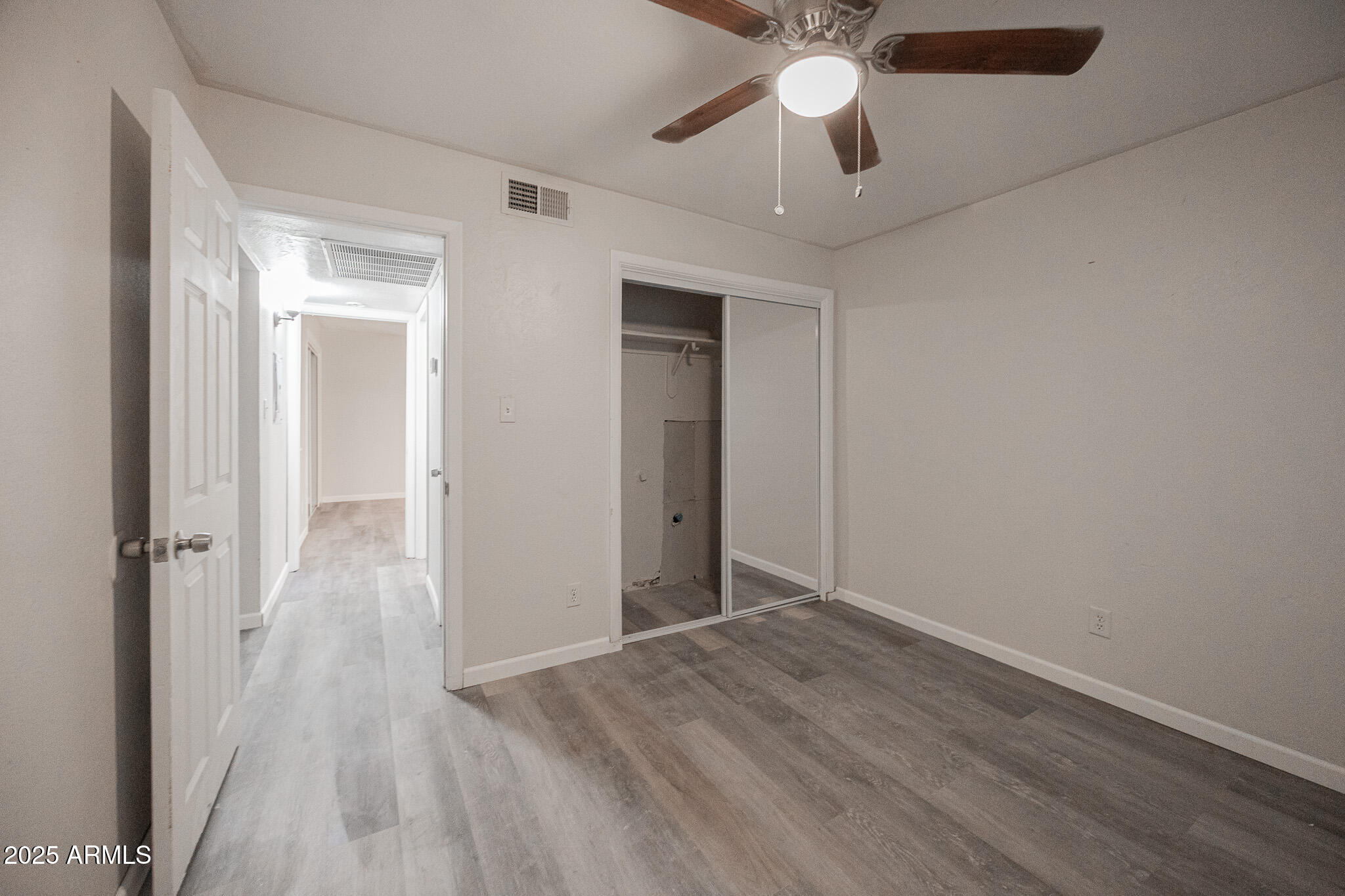 2340 East Broadway Road, Unit A Mesa, AZ 85204 - Photo 9 of 14 wooden floor in an empty room with a window