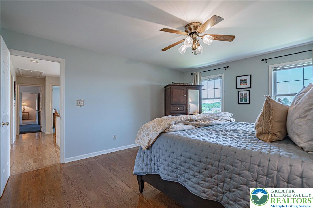 4542 Springfield Drive Coplay, PA 18037 - Photo 41 of 89 Hardwood floors and a gentle ceiling fan create a comfortable and serene bedroom.
