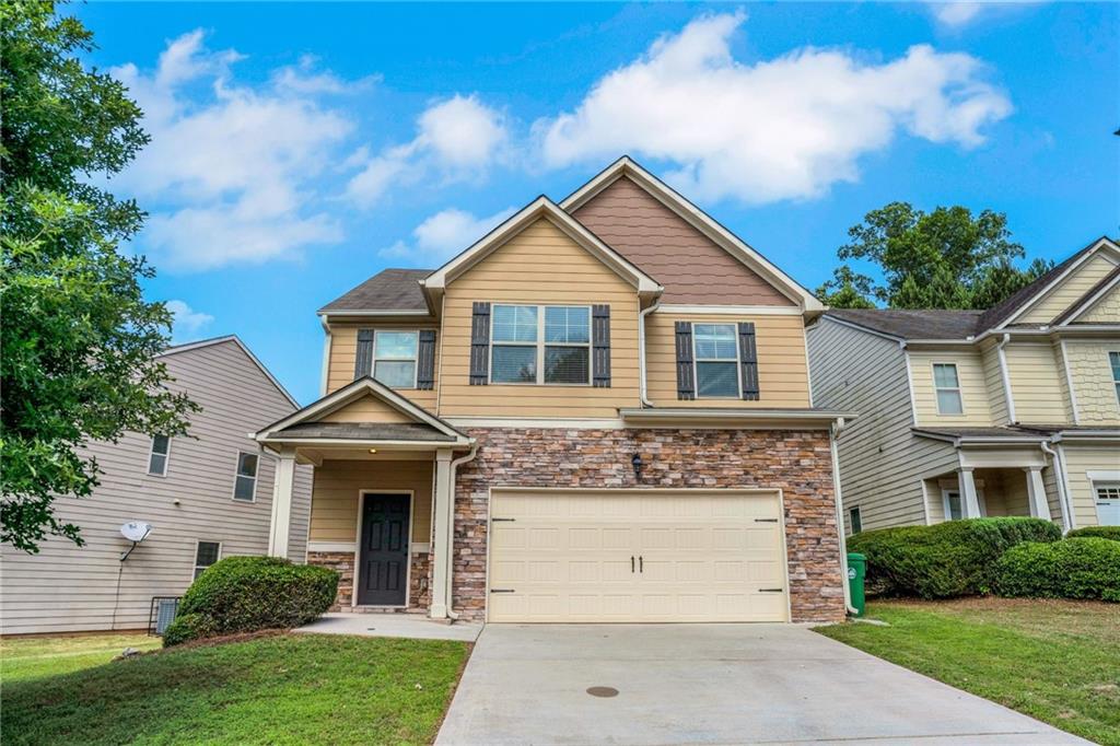 5123 Jack Drive Decatur, GA 30035 - Photo 1 of 1 a front view of a house with a yard and garage