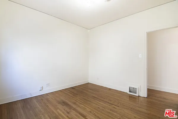 a view of a room with wooden floor