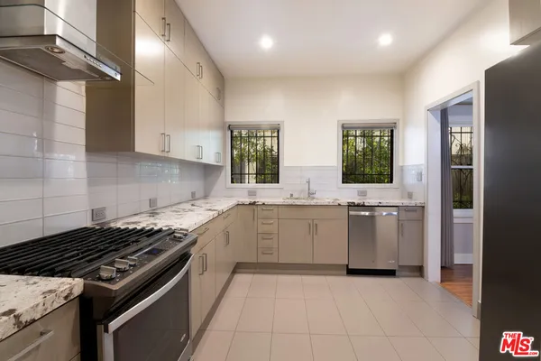 a kitchen with a sink stove and refrigerator