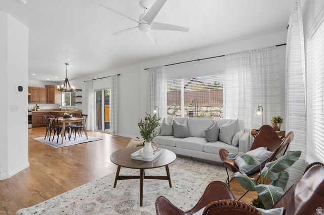 2007 Fielding Hill Lane Draper, UT 84020 - Photo 11 of 83 Open-concept living space featuring wood-finish flooring, a white ceiling fan, and sliding glass door access to the exterior