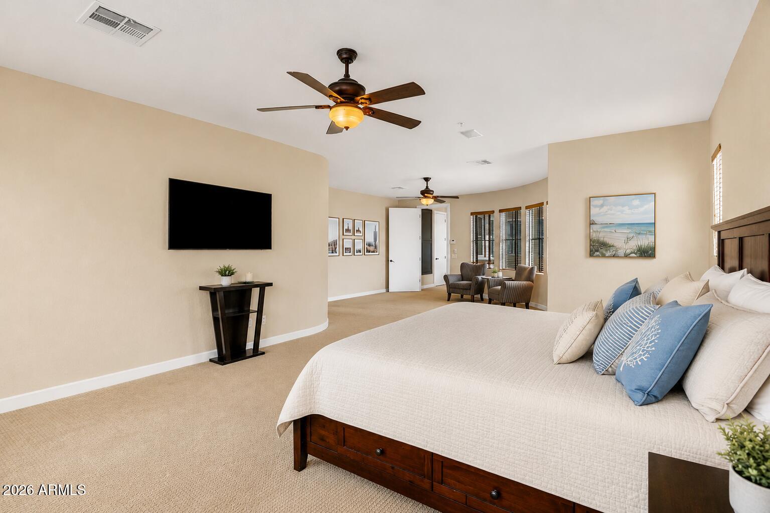 9572 East Mountain Spring Road Scottsdale, AZ 85255 - Photo 27 of 49 a spacious bedroom with a bed and a flat screen tv