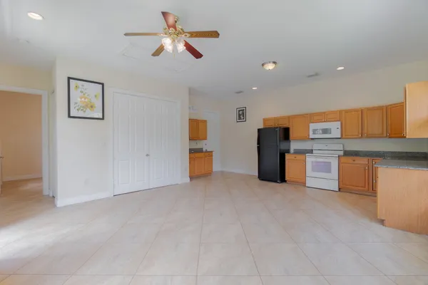 a view of kitchen with furniture and refrigerator