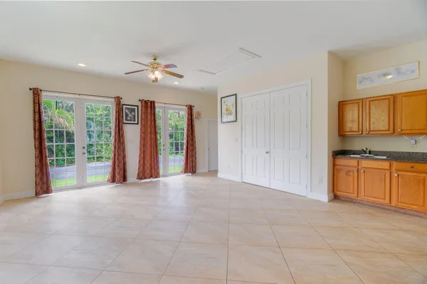 a view of an empty room with window and cabinet