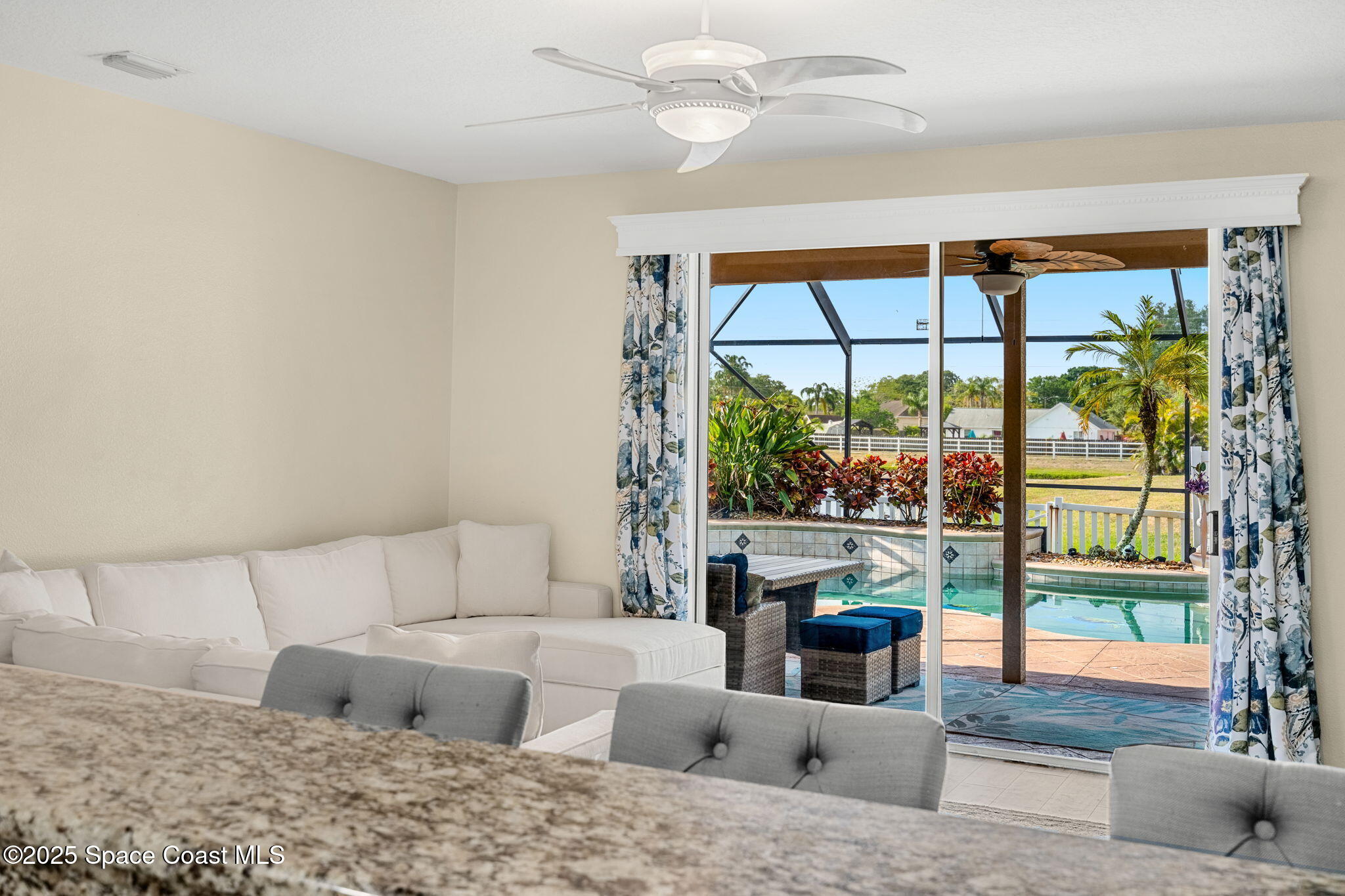 1331 Enclave Drive Rockledge, FL 32955 - Photo 12 of 43 a living room with furniture and a large window with outer view