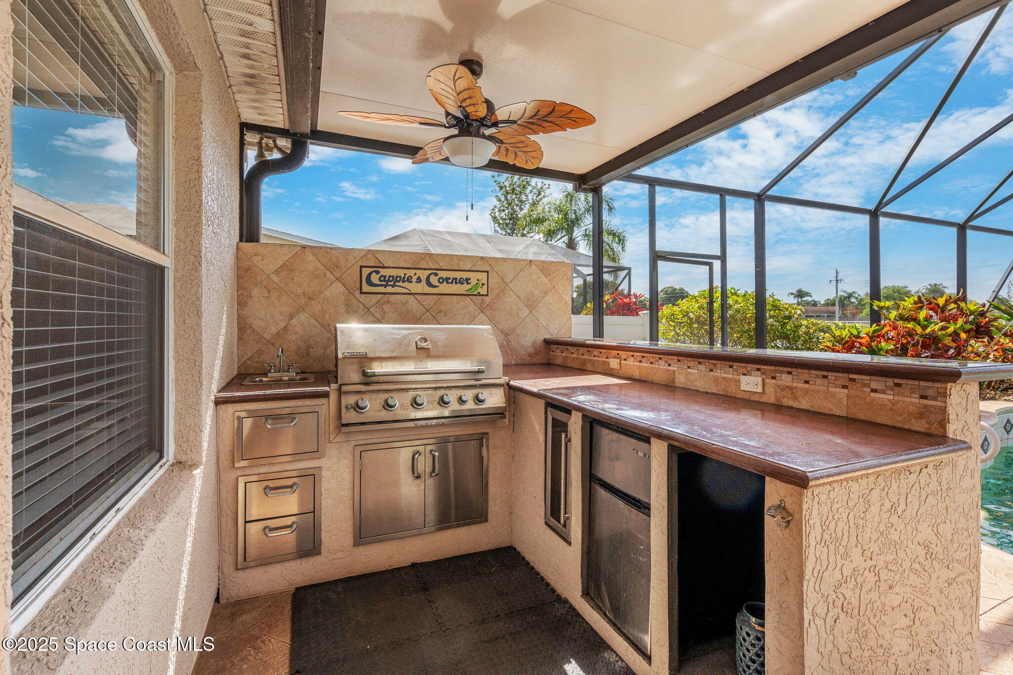 1331 Enclave Drive Rockledge, FL 32955 - Photo 33 of 43 a kitchen with stainless steel appliances granite countertop a stove and a refrigerator