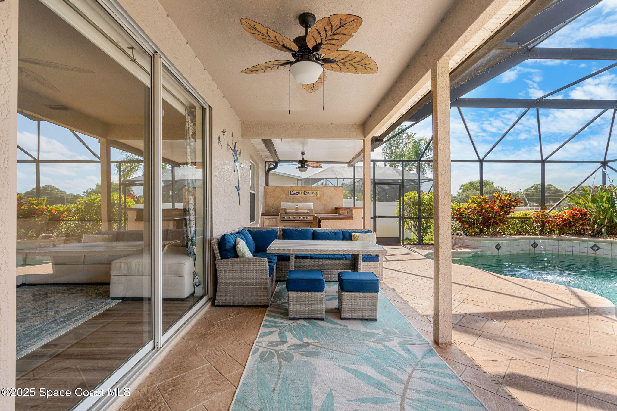 1331 Enclave Drive Rockledge, FL 32955 - Photo 34 of 43 a living room with furniture and a floor to ceiling window