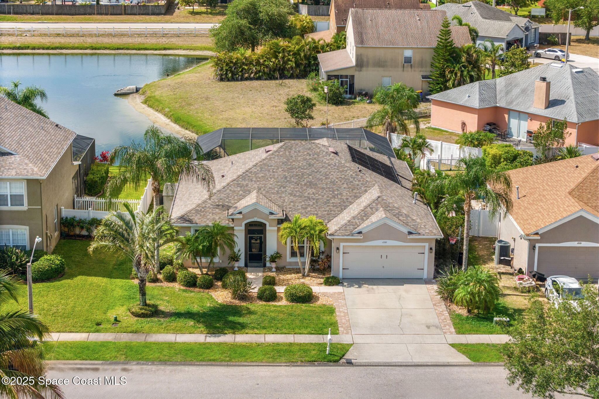 1331 Enclave Drive Rockledge, FL 32955 - Photo 37 of 43 front view of house with a yard and potted plants