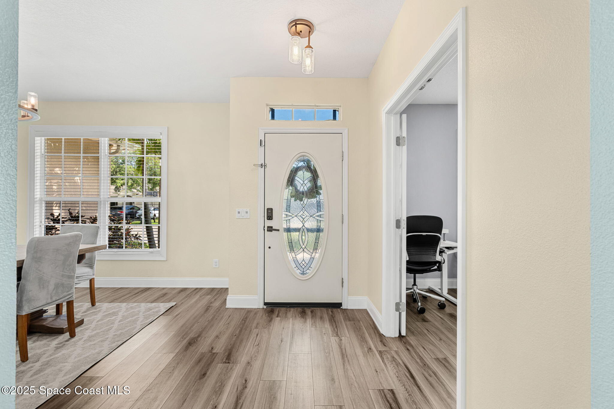 1331 Enclave Drive Rockledge, FL 32955 - Photo 4 of 43 an entryway at a room window and wooden floor