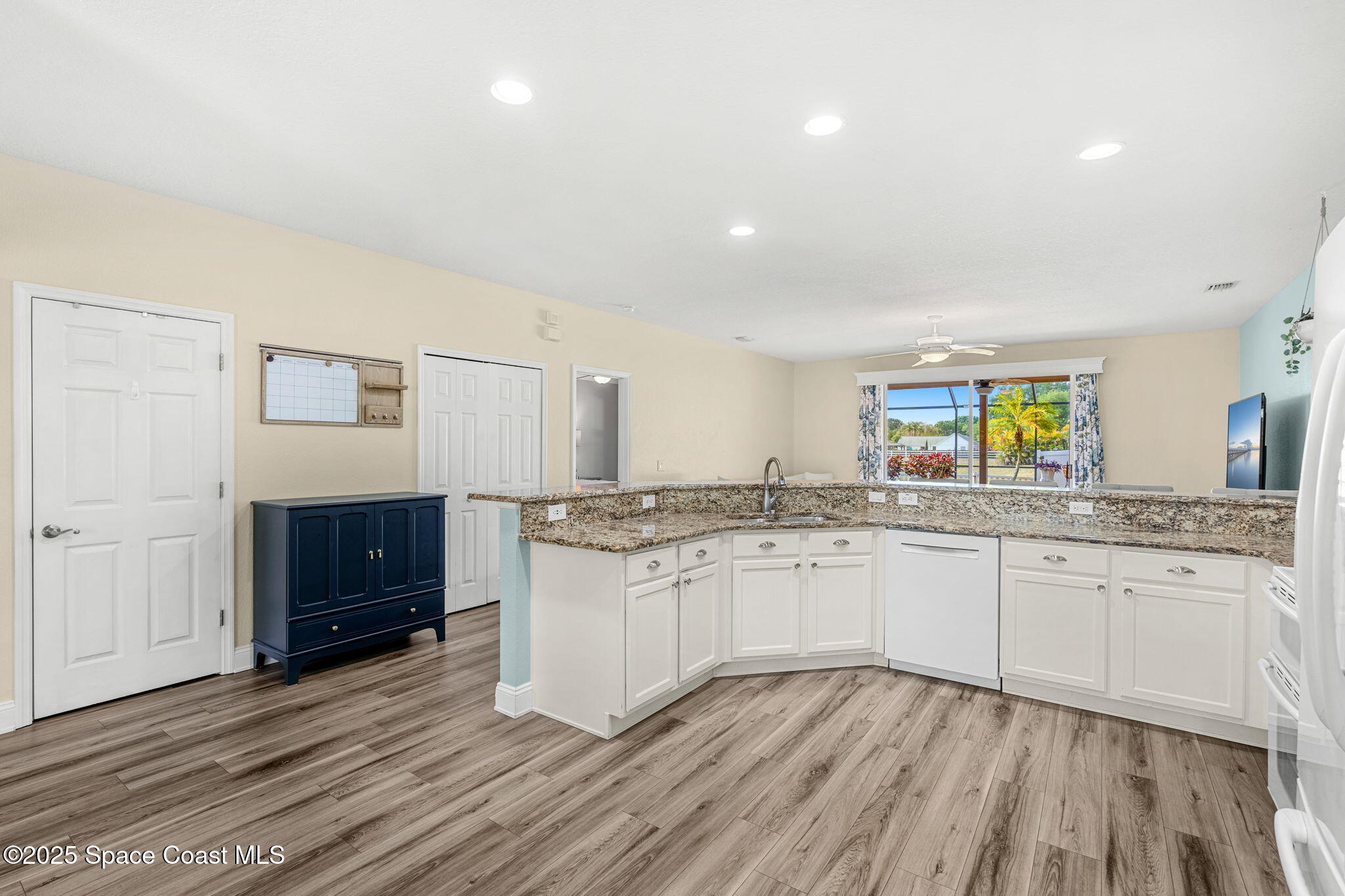1331 Enclave Drive Rockledge, FL 32955 - Photo 9 of 43 a kitchen with granite countertop a stove a sink and a refrigerator