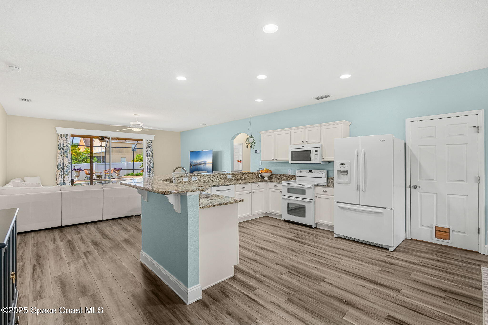 1331 Enclave Drive Rockledge, FL 32955 - Photo 10 of 43 a large kitchen with cabinets wooden floor and stainless steel appliances