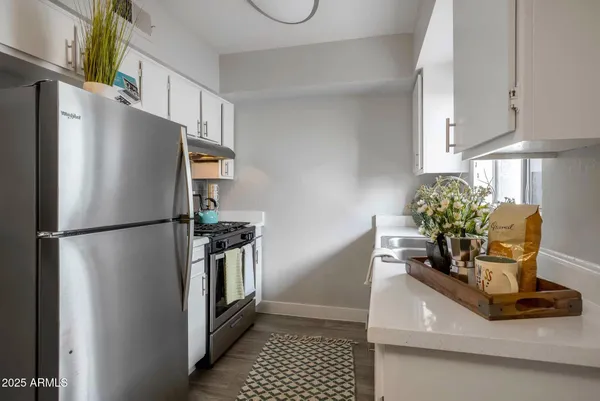 a kitchen with a refrigerator and a sink