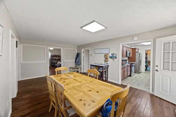 a view of a dining room with furniture and wooden floor