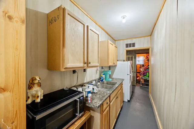 a kitchen with a sink and a stove top oven