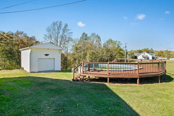 a view of a house with a backyard and deck