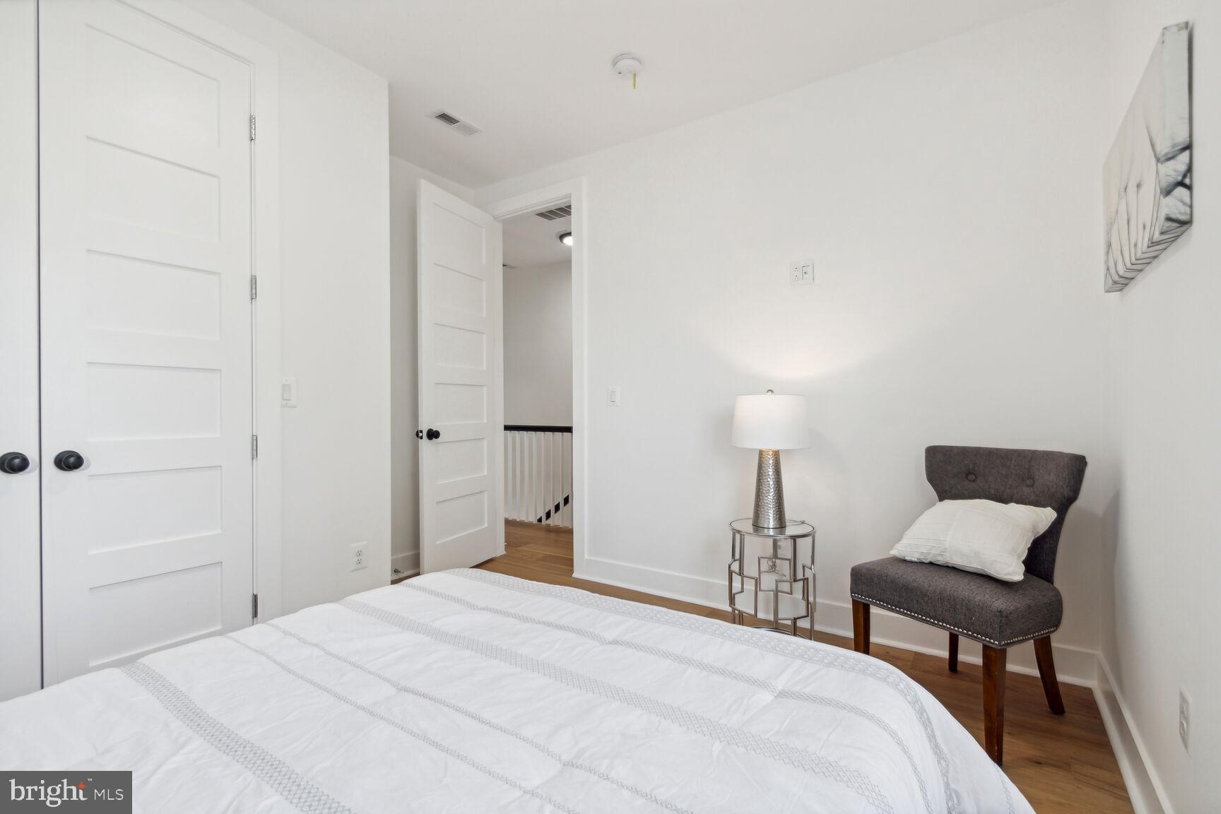 1410 A Street Northeast Washington, DC 20002 - Photo 14 of 35 a bedroom with a bed and a chair