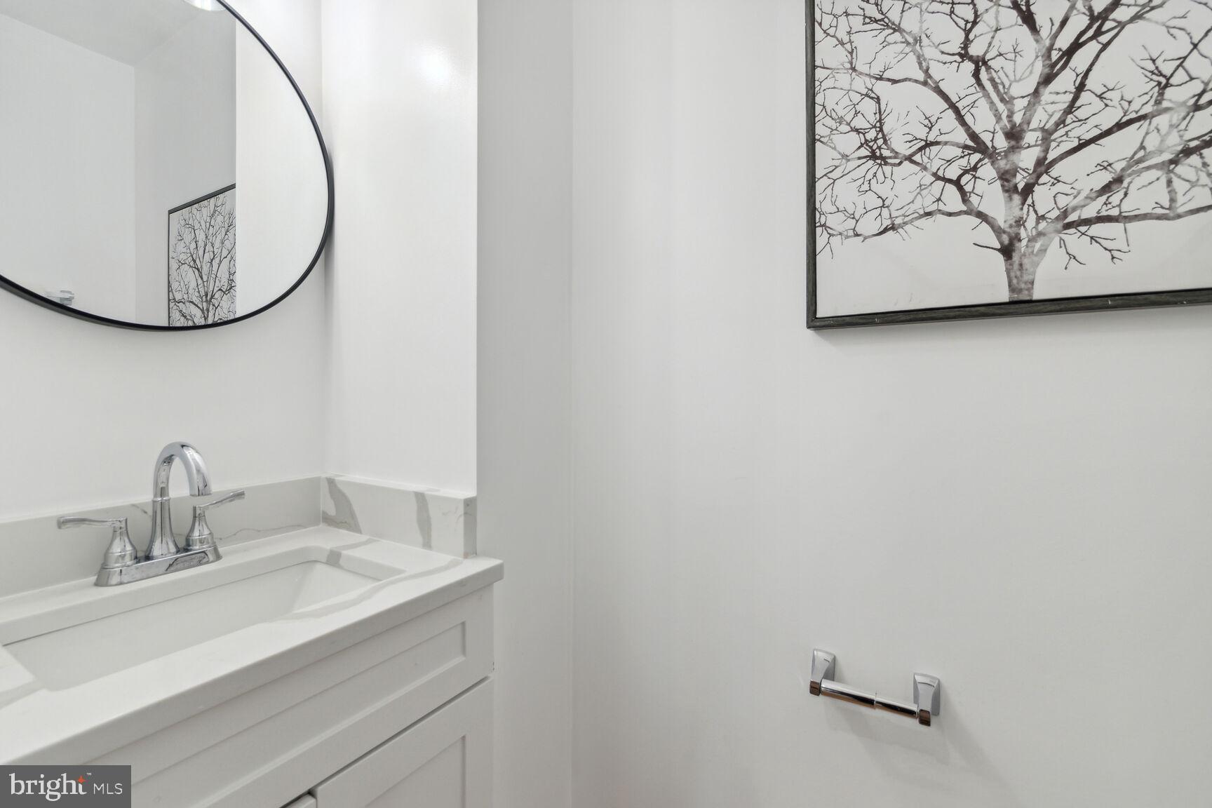 1410 A Street Northeast Washington, DC 20002 - Photo 17 of 35 a bathroom with a sink and a mirror