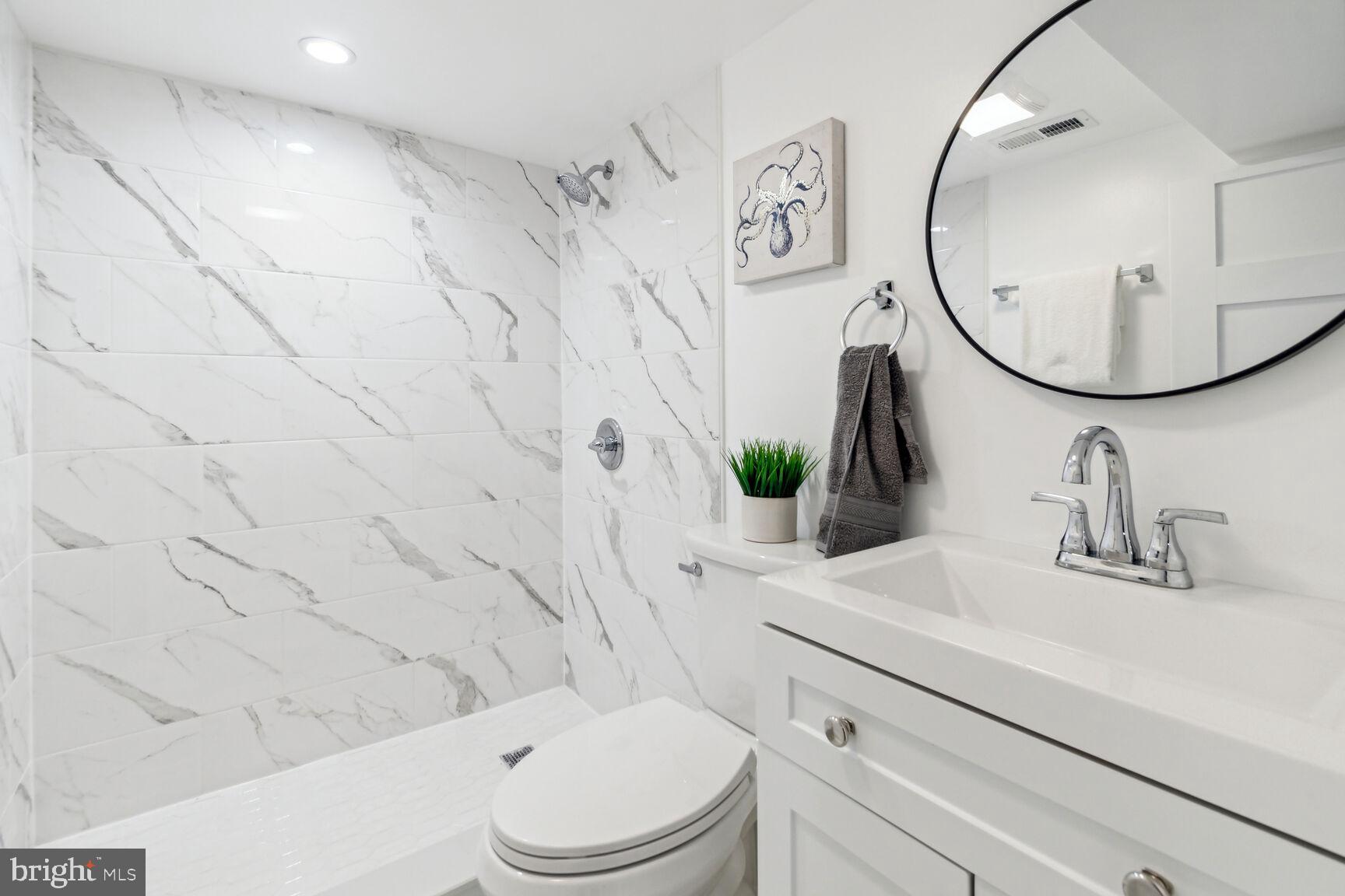 1410 A Street Northeast Washington, DC 20002 - Photo 22 of 35 a bathroom with a granite countertop sink mirror vanity and toilet