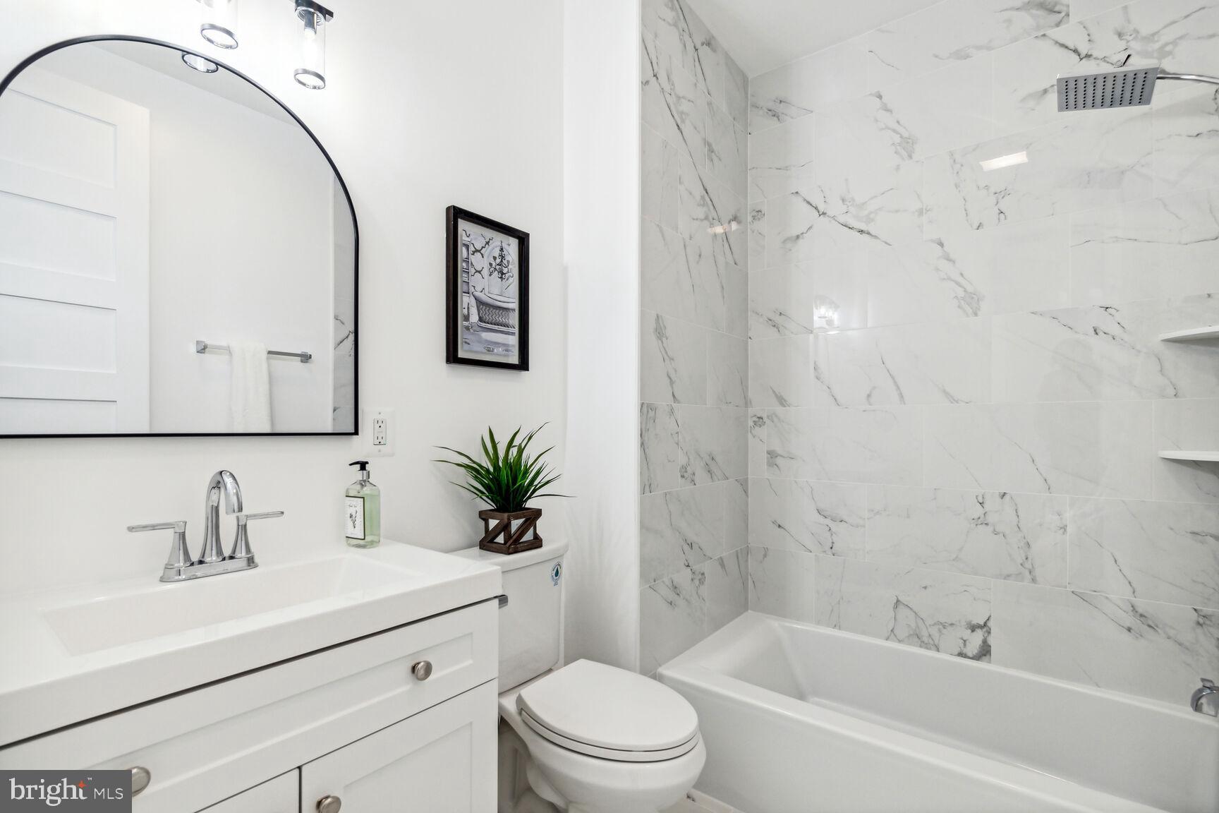 1410 A Street Northeast Washington, DC 20002 - Photo 23 of 35 a bathroom with a sink a toilet and shower