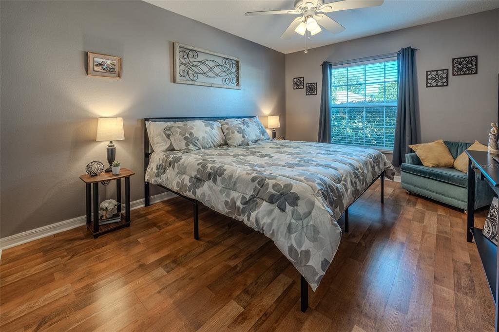 15143 Southwest 14th Avenue Road Ocala, FL 34473 - Photo 27 of 53 a bedroom with a bed and a chandelier