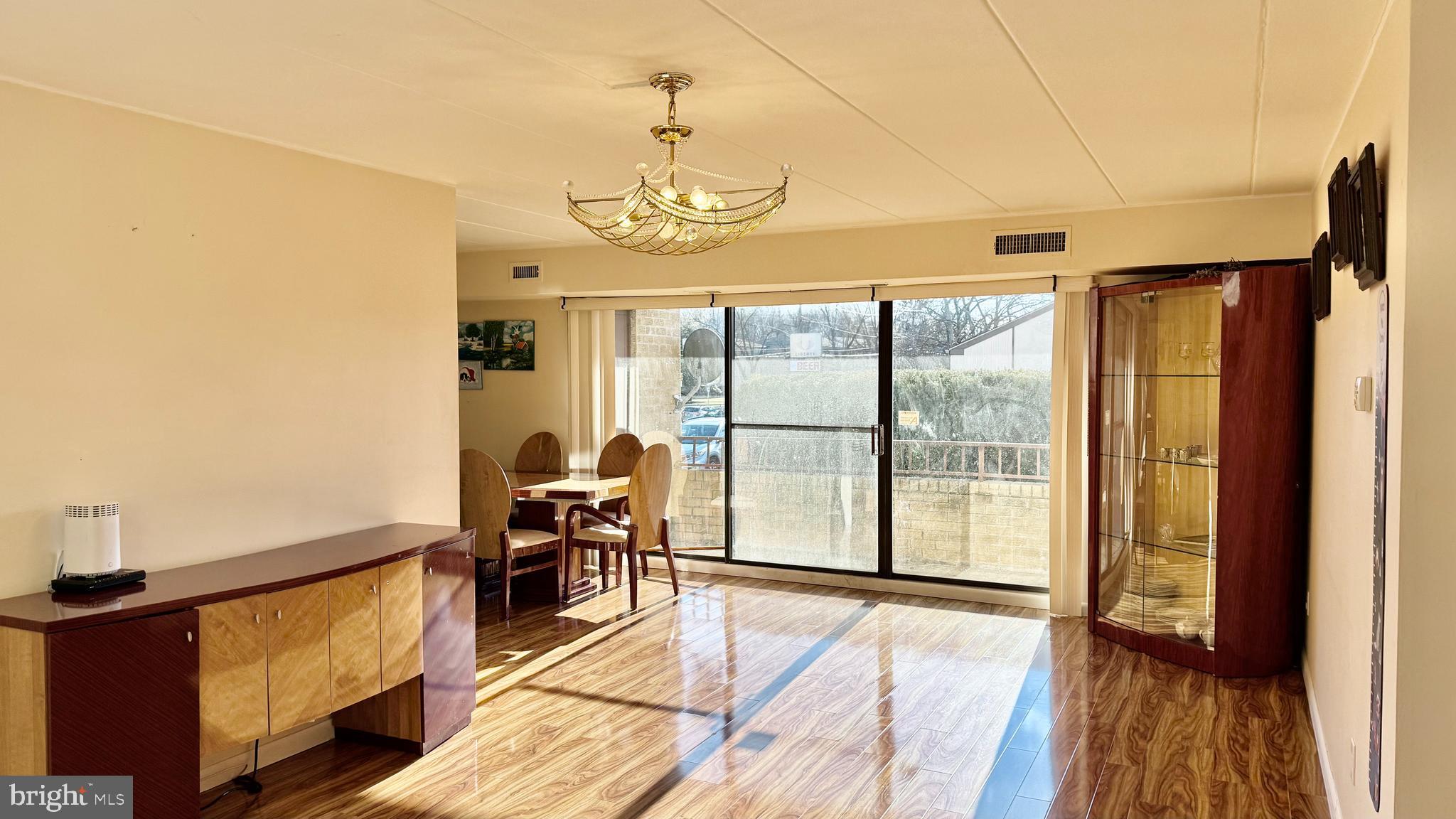 8910 Krewstown Road, Unit 118 Philadelphia, PA 19115 - Photo 12 of 15 a view of a livingroom with furniture wooden floor and window