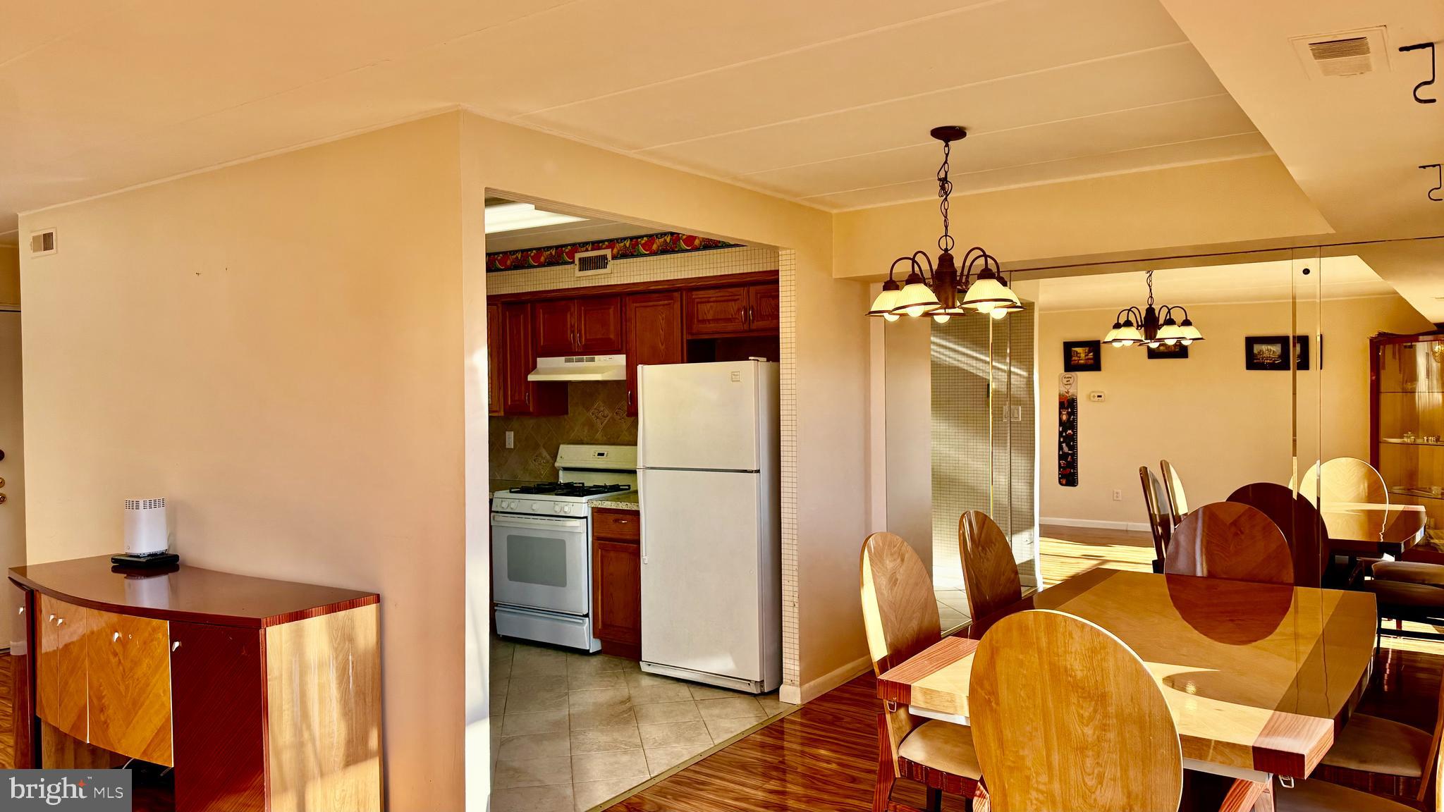 8910 Krewstown Road, Unit 118 Philadelphia, PA 19115 - Photo 14 of 15 a view of a kitchen with stainless steel appliances granite countertop a refrigerator and a stove top oven