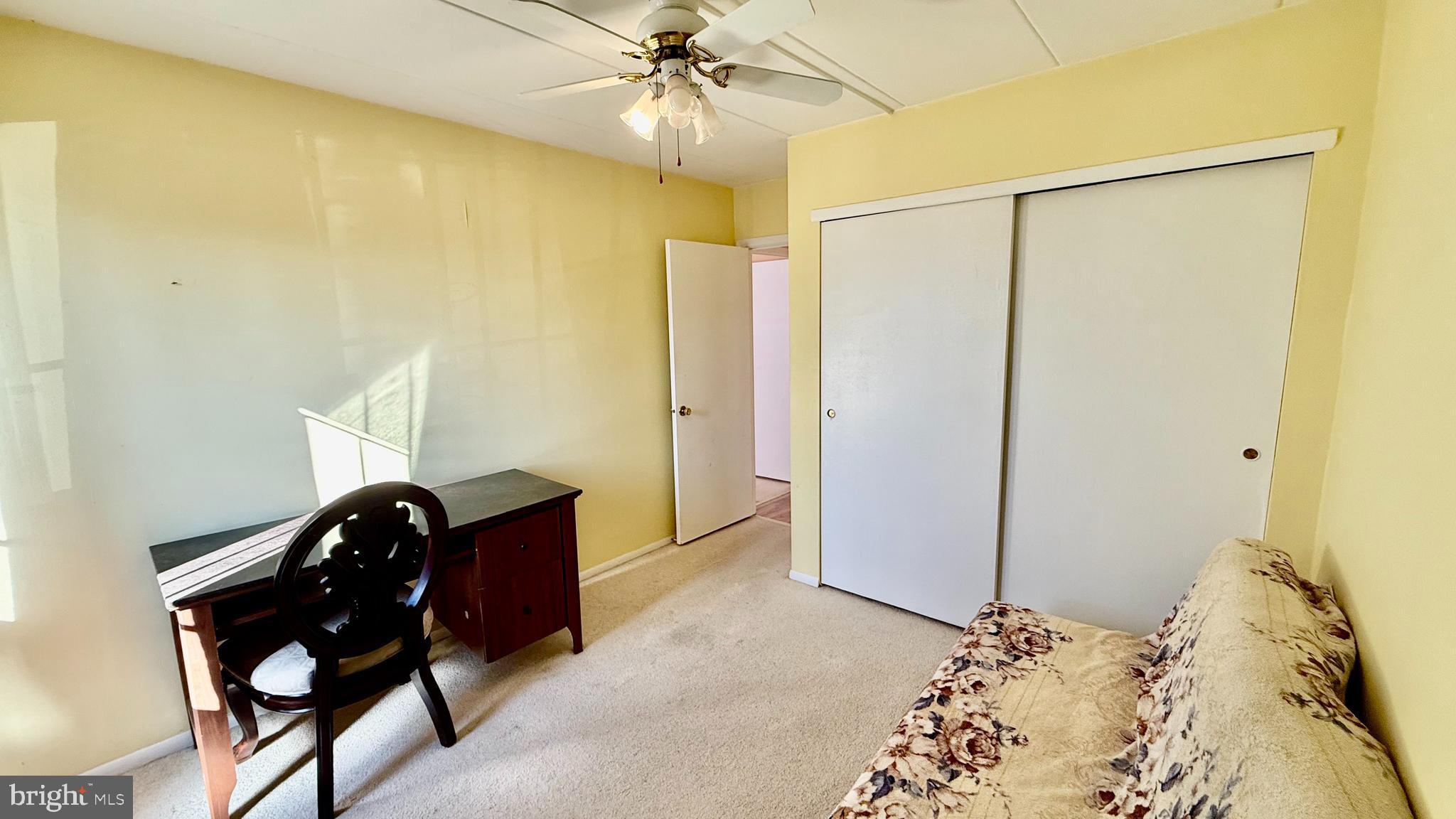 8910 Krewstown Road, Unit 118 Philadelphia, PA 19115 - Photo 6 of 15 a bedroom with a bed and a chandelier fan