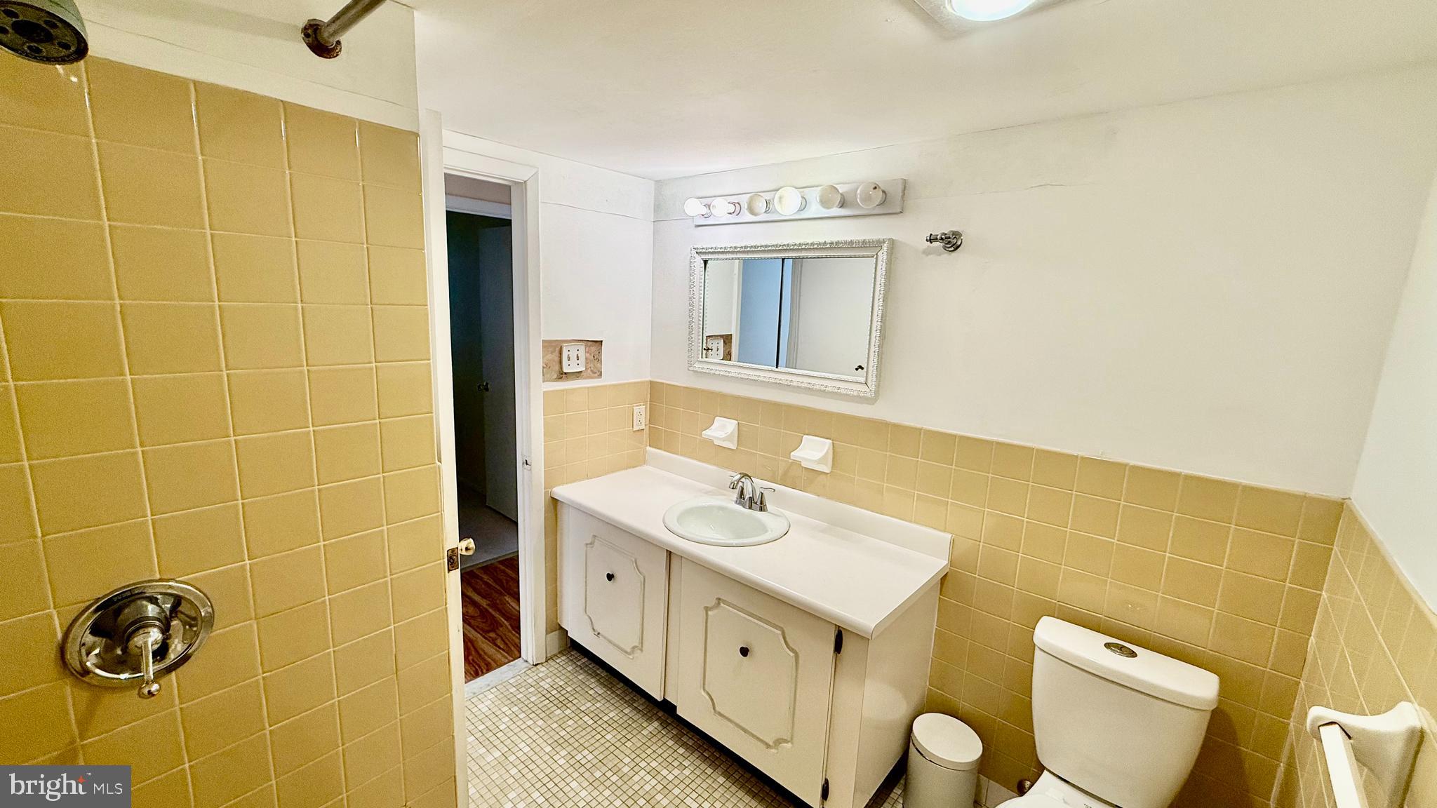 8910 Krewstown Road, Unit 118 Philadelphia, PA 19115 - Photo 8 of 15 a bathroom with a double vanity sink mirror and toilet