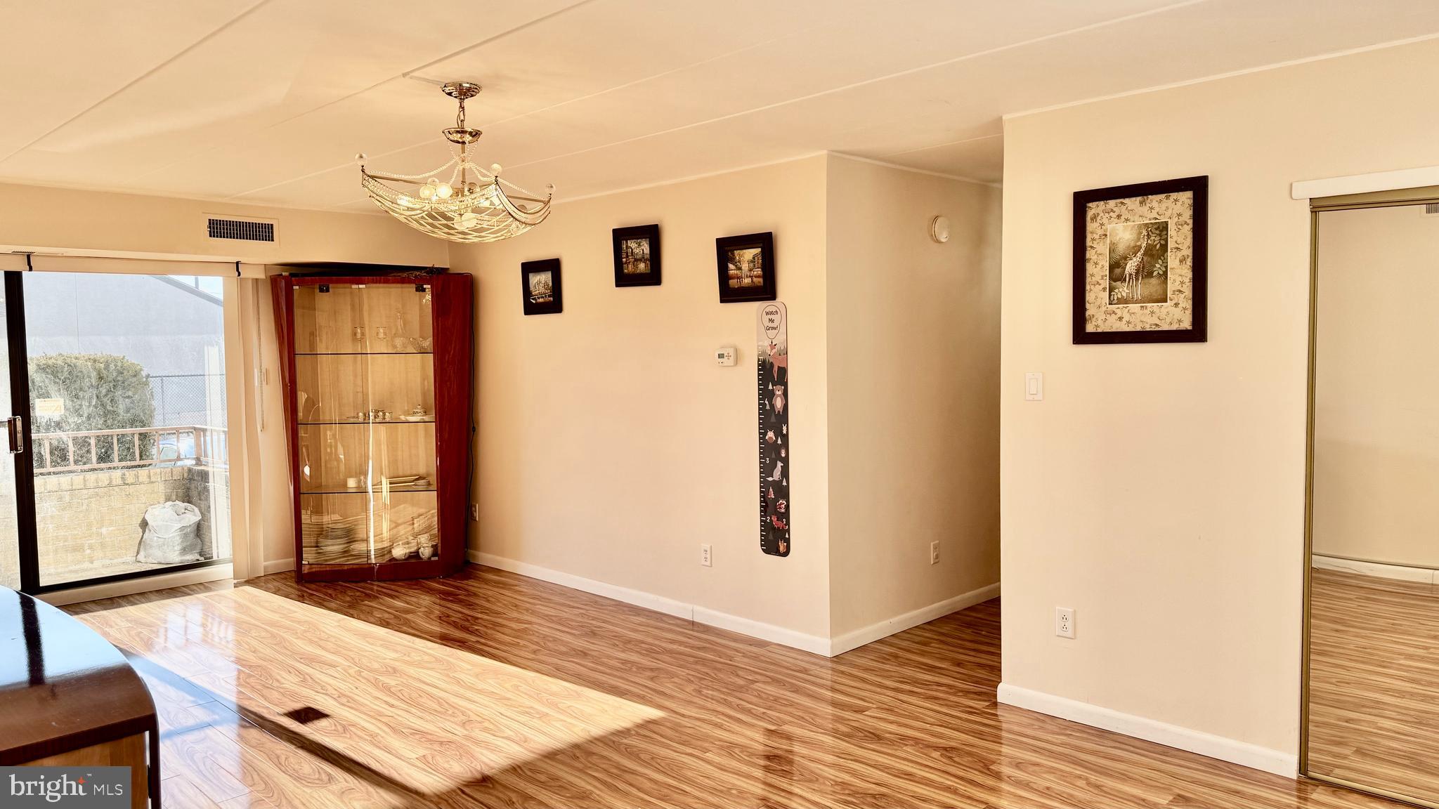 8910 Krewstown Road, Unit 118 Philadelphia, PA 19115 - Photo 9 of 15 a view of a livingroom with wooden floor and a ceiling fan