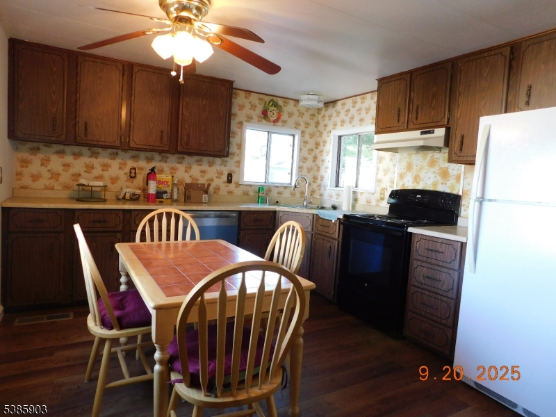 59 Back Street Oxford, NJ 07863 - Photo 14 of 25 a kitchen with granite countertop a dining table chairs and a refrigerator