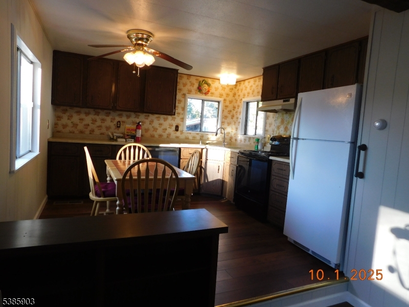 59 Back Street Oxford, NJ 07863 - Photo 16 of 25 a kitchen with stainless steel appliances granite countertop a refrigerator a stove a sink a dining table and chairs