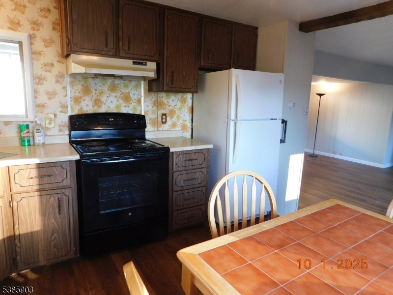 59 Back Street Oxford, NJ 07863 - Photo 17 of 25 a kitchen with stainless steel appliances a stove a refrigerator and a sink with wooden cabinets
