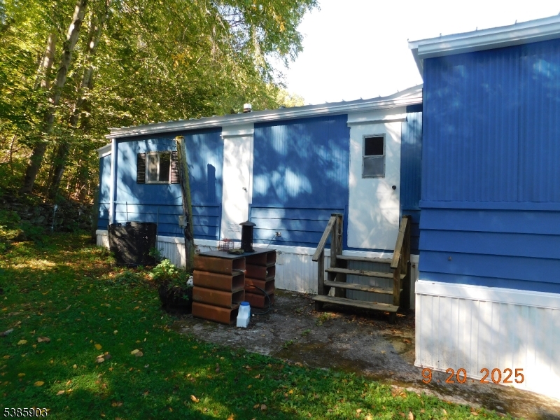 59 Back Street Oxford, NJ 07863 - Photo 4 of 25 a backyard of a house with barbeque oven and outdoor seating