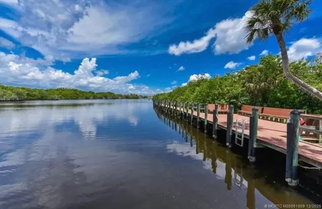 a view of a lake with couches chairs
