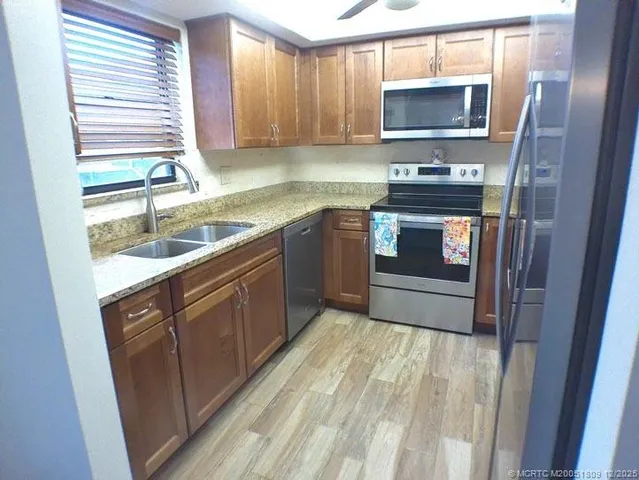 a kitchen with a stove sink and microwave
